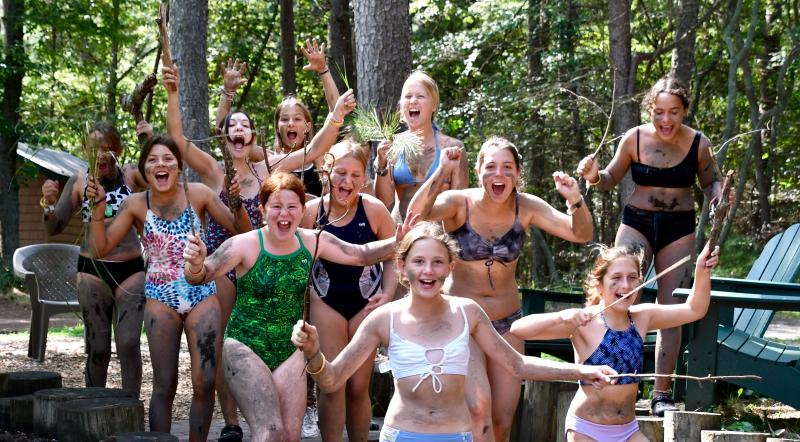 No, this is not what campers look like at the end of the week. They are participating in a camouflage activity with the camp’s naturalist.